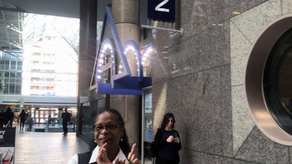 A worker celebrates joining Unifor outside the Novotel hotel.