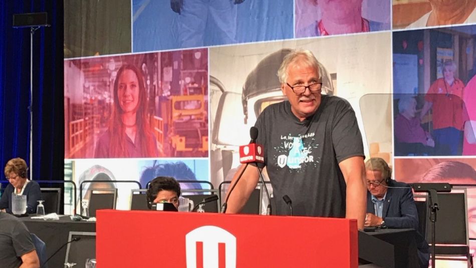 Renaud Gagné addresses delegates from behind a microphone at Canadian Council.