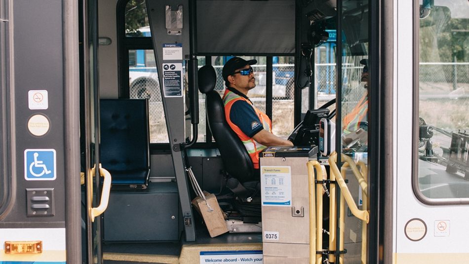 A Unifor member drives a city bus.