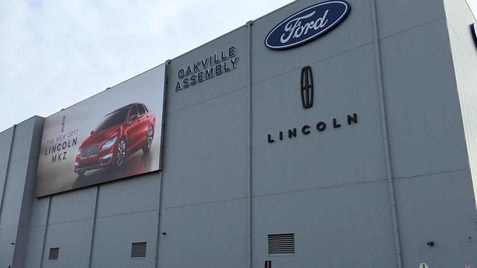 The side of Ford's Oakville Assembly plant shows and ad for the Lincoln MKZ.