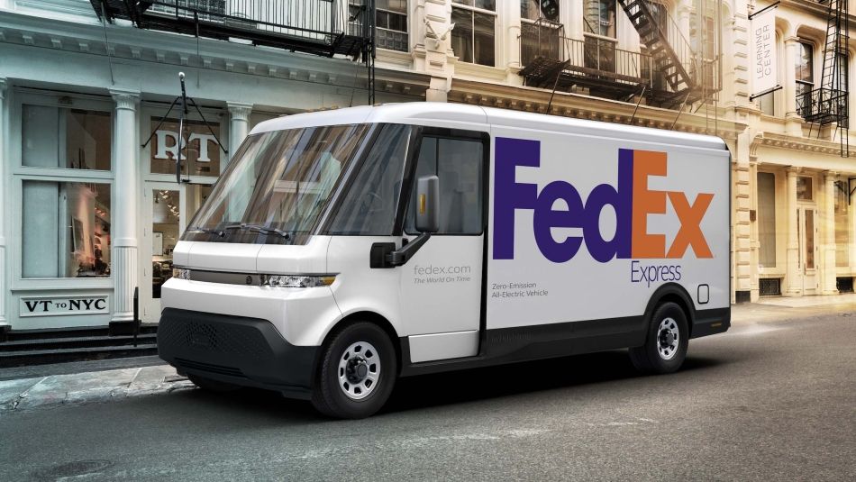 An all-electric FedEx van is parked on a city street.