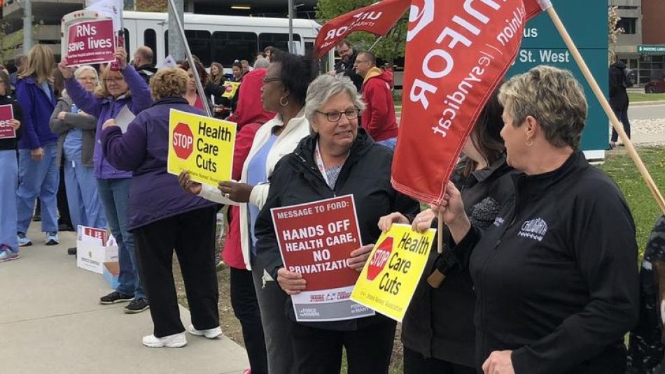 Health care activists attend a rally.