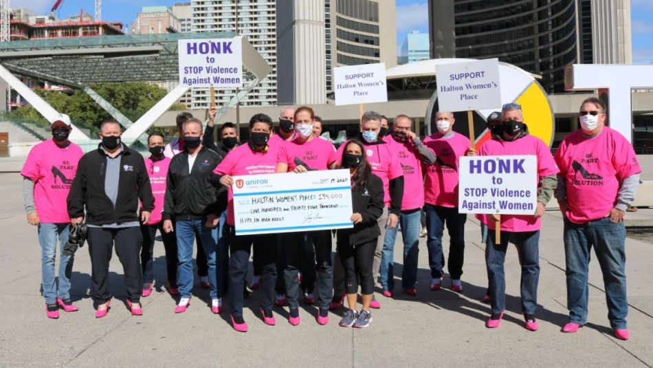 Jerry Dias and a group of activists present a cheque to Halton Women's Place.