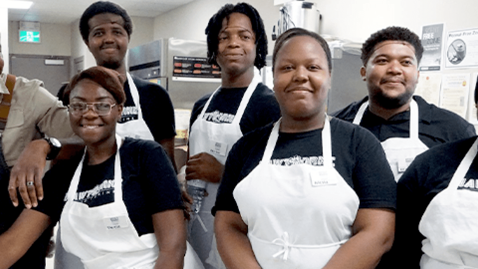 Trainees prepare meals in the Hospitality Workers Training Centre kitchen.