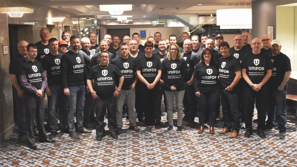 A large group of people wear matching "2018 Pulp & Paper Bargaining" t-shirts.
