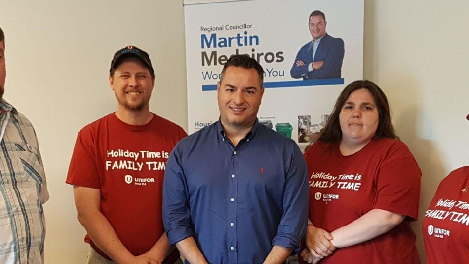 Des membres d'Unifor, debout avec le conseiller régionale de Brampton, Martin Medeiros.