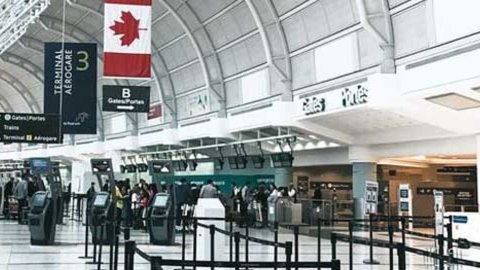 Pearson International Airport Terminal with travellers walking inside.