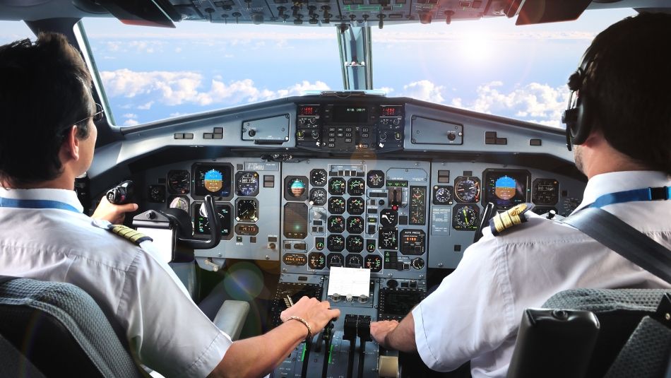 two pilots in the cockpit of an airplane