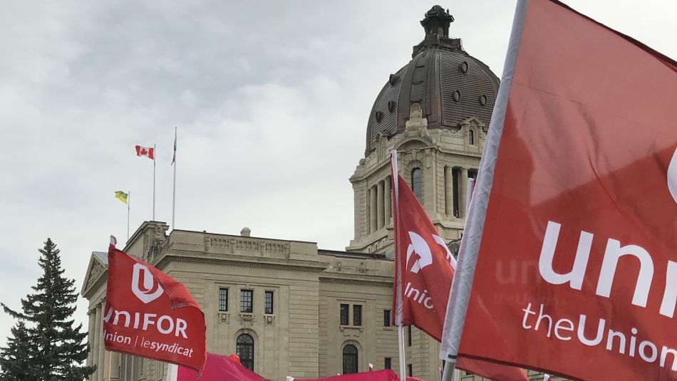 Unifor flags flie in front of the Saskatechawn provincial legislature.