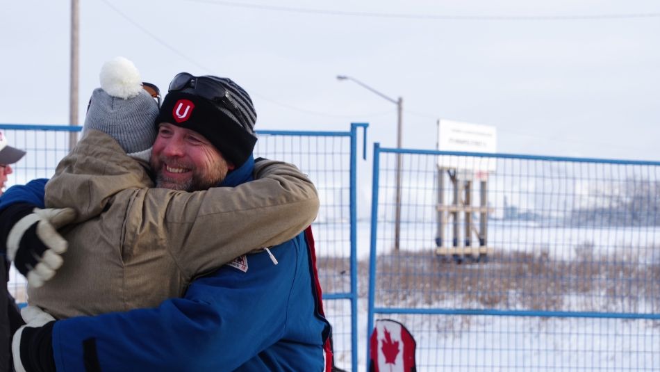 Unifor members share a hug on the picket line at Co-op Refinery.