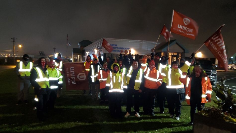 Chris MacDonald and members of Unifor Local 597 on a picket line at night.