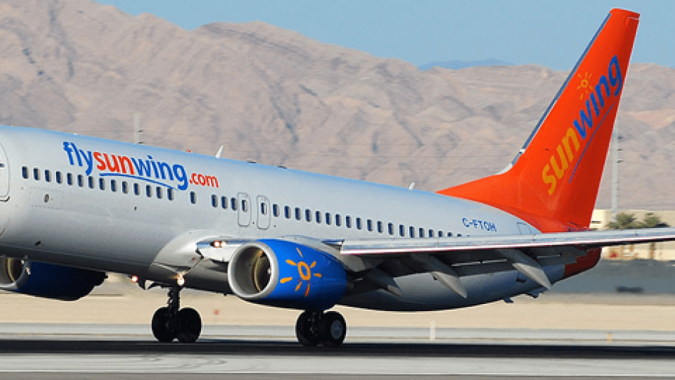 A Sunwing airplane taking off.