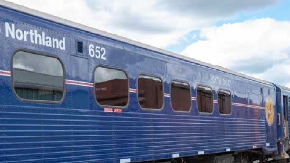 An Ontario Northland train waits at a station.