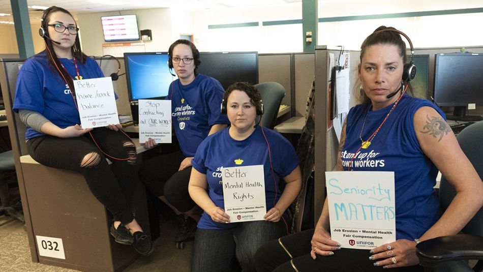 Four Unifor members wearing headsets sit at their workstations.