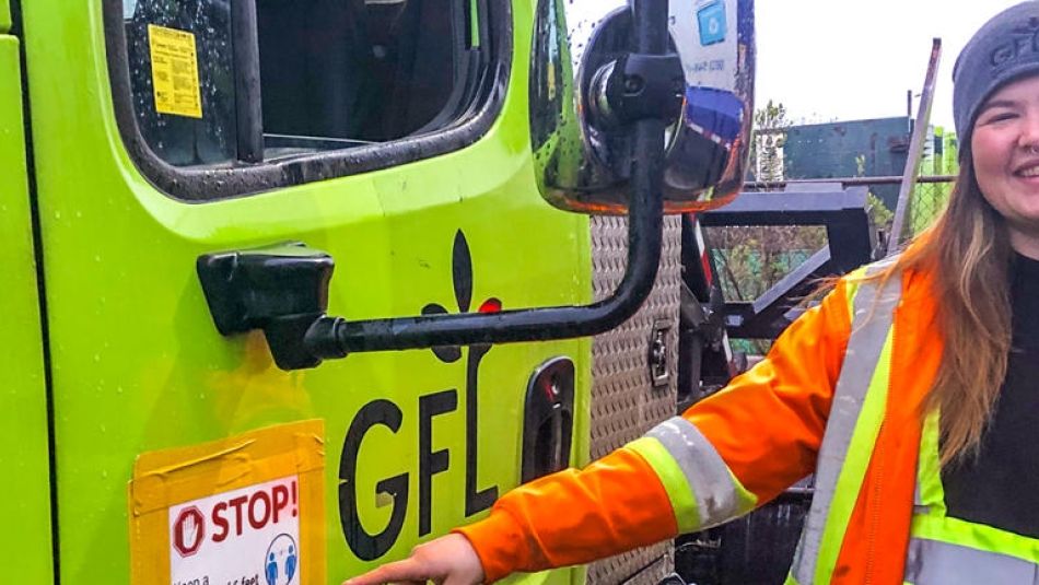 A member of Local 4268 wears brightly coloured safety clothing while standing next to a work vehicle.