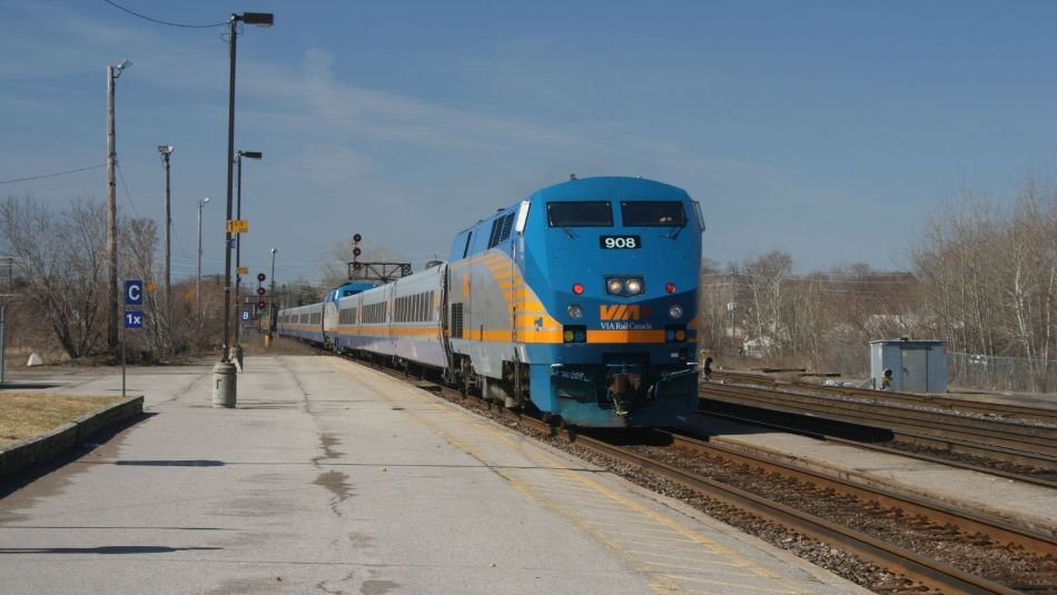 A VIA rail train pulls into a station.