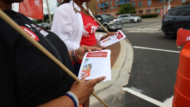 A women holding a flag and leaflet