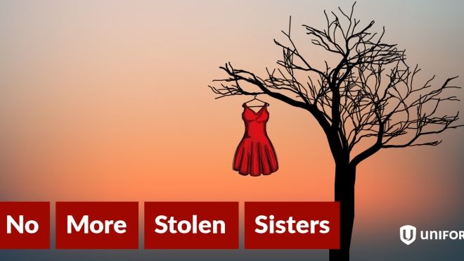 a red dress hanging in a dead tree