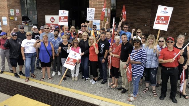 Large group of picketers posing for a photo