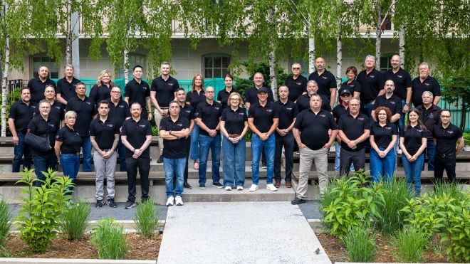 A large group outside wearing black Unifor AutoTalks t-shirts