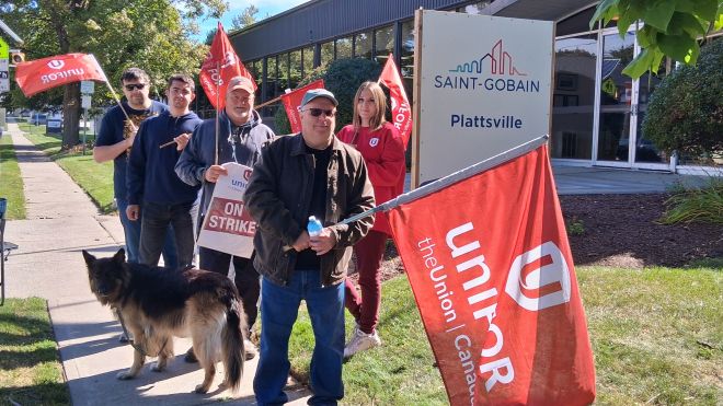 a group outside holding flags and placcards