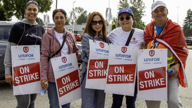 A group of people wearing on strike signs