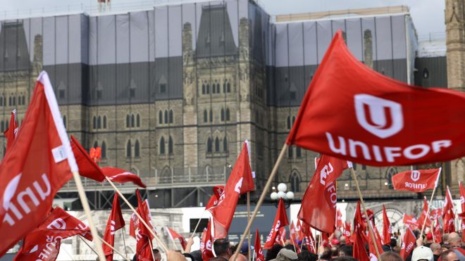 Unifor flags fly in front of Parliament Hill