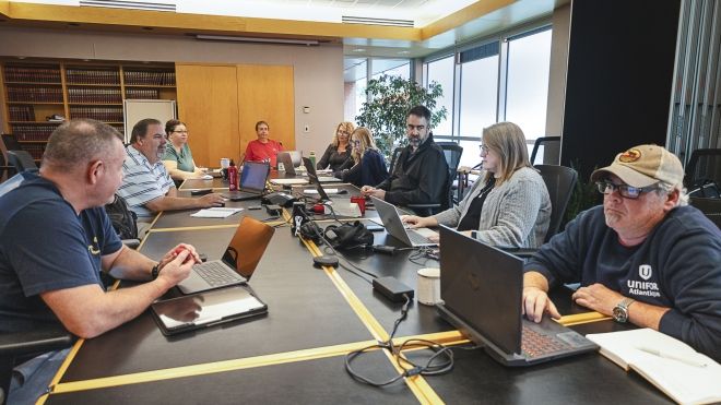 A group of people working around a table.