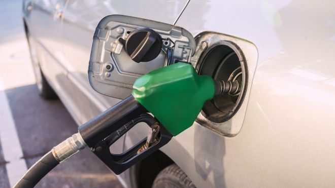 Gas pump handle inserted into a car's gas tank