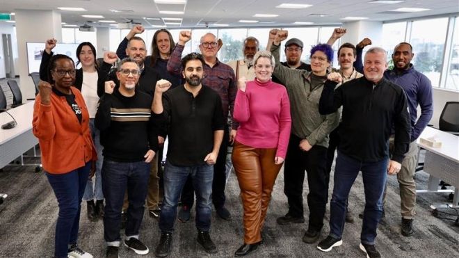A group of people posing with their fists raised.