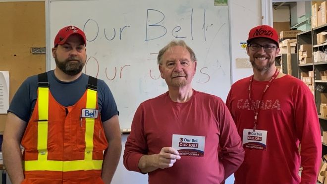 three Bell Atlantic members smiling holding Our Bell Our Jobs postcards