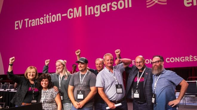 Leadership on stage at convention with members from GM Ingersoll