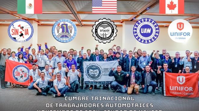 A large group with Canada, USA and Mexico flags