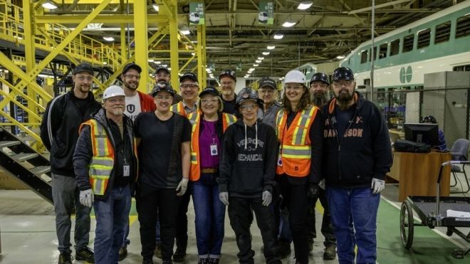 A workplace tour group in hardhats