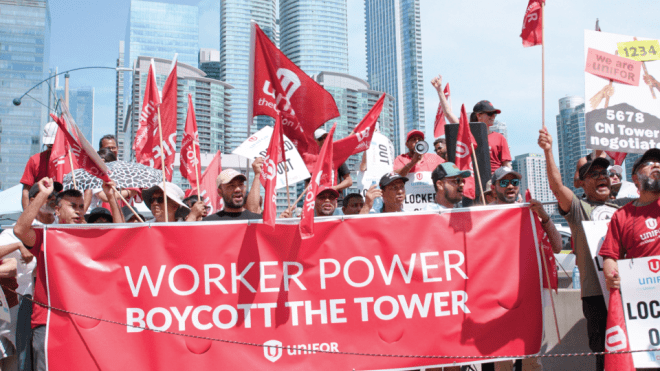 group of people holding a banner 