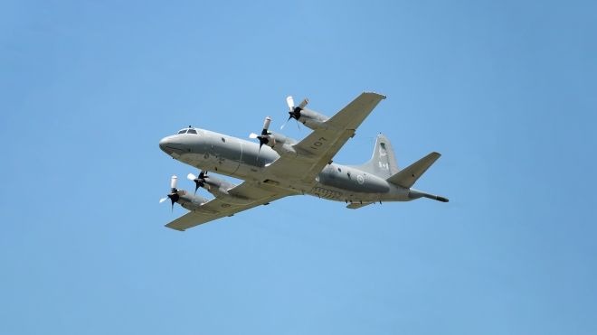 CP-140 Aurora vieweing in flight from below against a blue sky