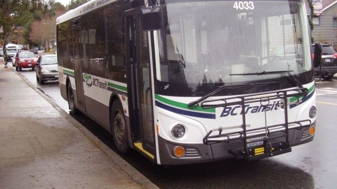 A transit bus parked on the roadside.