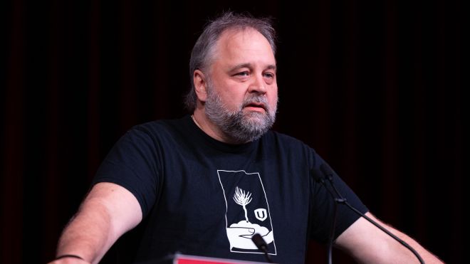 A man in a fight for forestry t-shirt at a podium