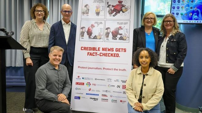 six people beside a x-stand banner, Credible news gets fack checked.