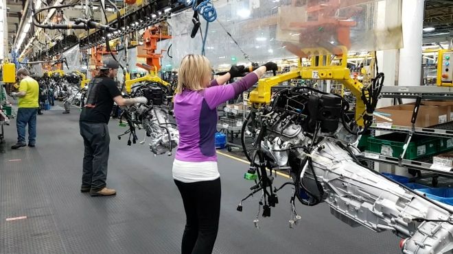 Members working on the line in an auto factory.