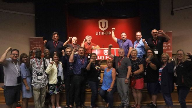 A group of people raising their fists in the air in solidarity.
