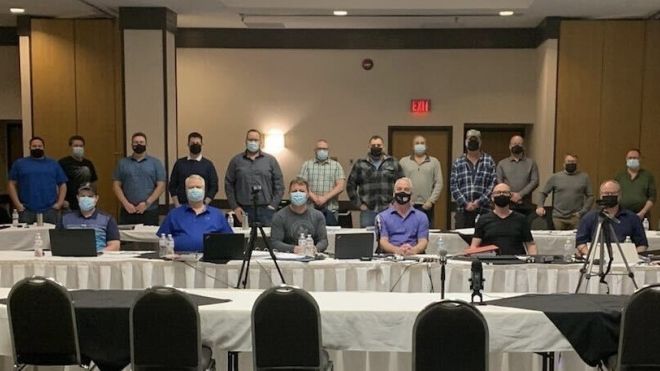 Pulp Bargaining Committee sits at board table 
