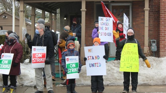 Members on the picket line holding on stike signs at Napanee’s Lennox and Addington Interval House