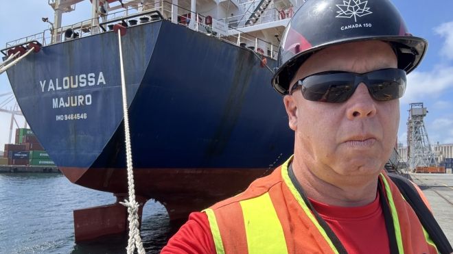 ITF Coordinator (Canada) Karl Risser stands in front of a ship docked at the port of Halifax