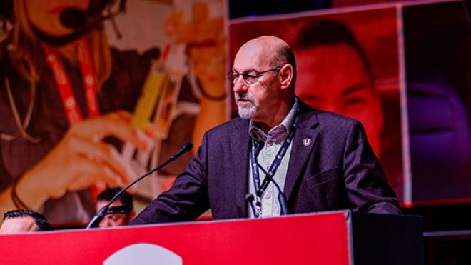a man speaks at a Unifor podium