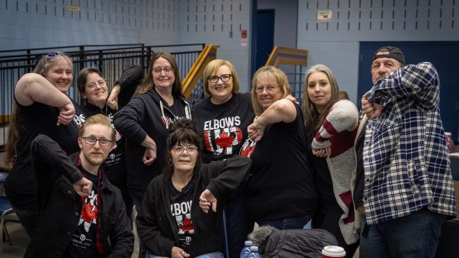 A group of people with their elbows up