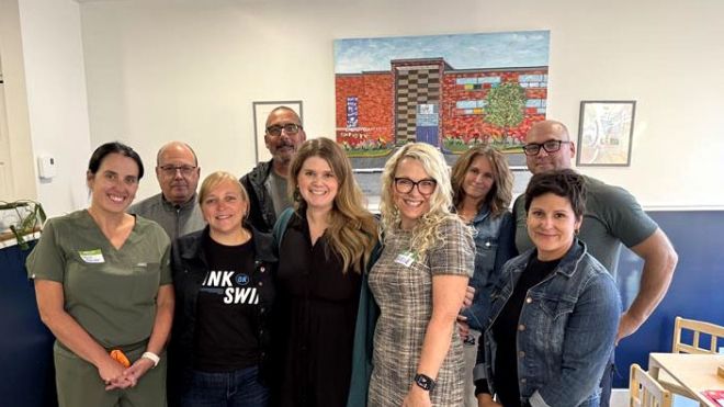 Unifor Atlantic Regional Director Jennifer Murray standing in an office with eight other people.