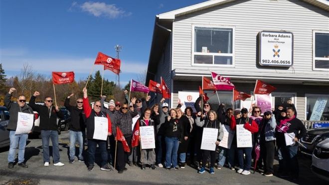 a large rally people holding placcards and flags outside Minister Michelle Thompson’s office in Antigonish, N.S. 