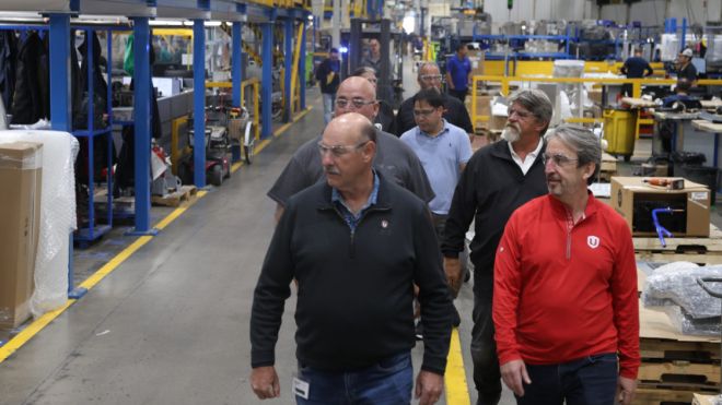 A group of people walking through a warehouse