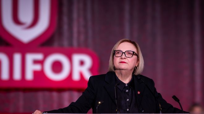 Lana Payne speaking at a podium